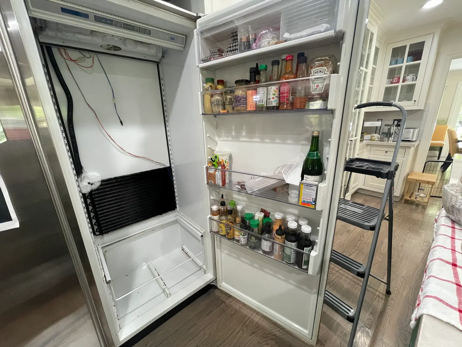 Sub-Zero refrigerator door overloaded with heavy bottles causing hinge and door sealing problems